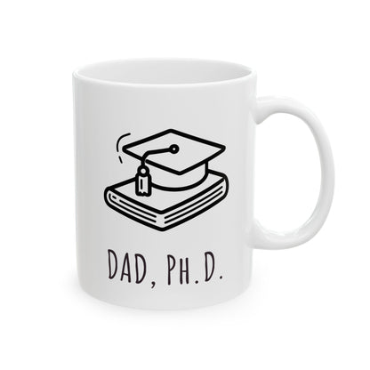 White mug with a graduation cap and books design and 'DAD, PH.D.' text on a white background